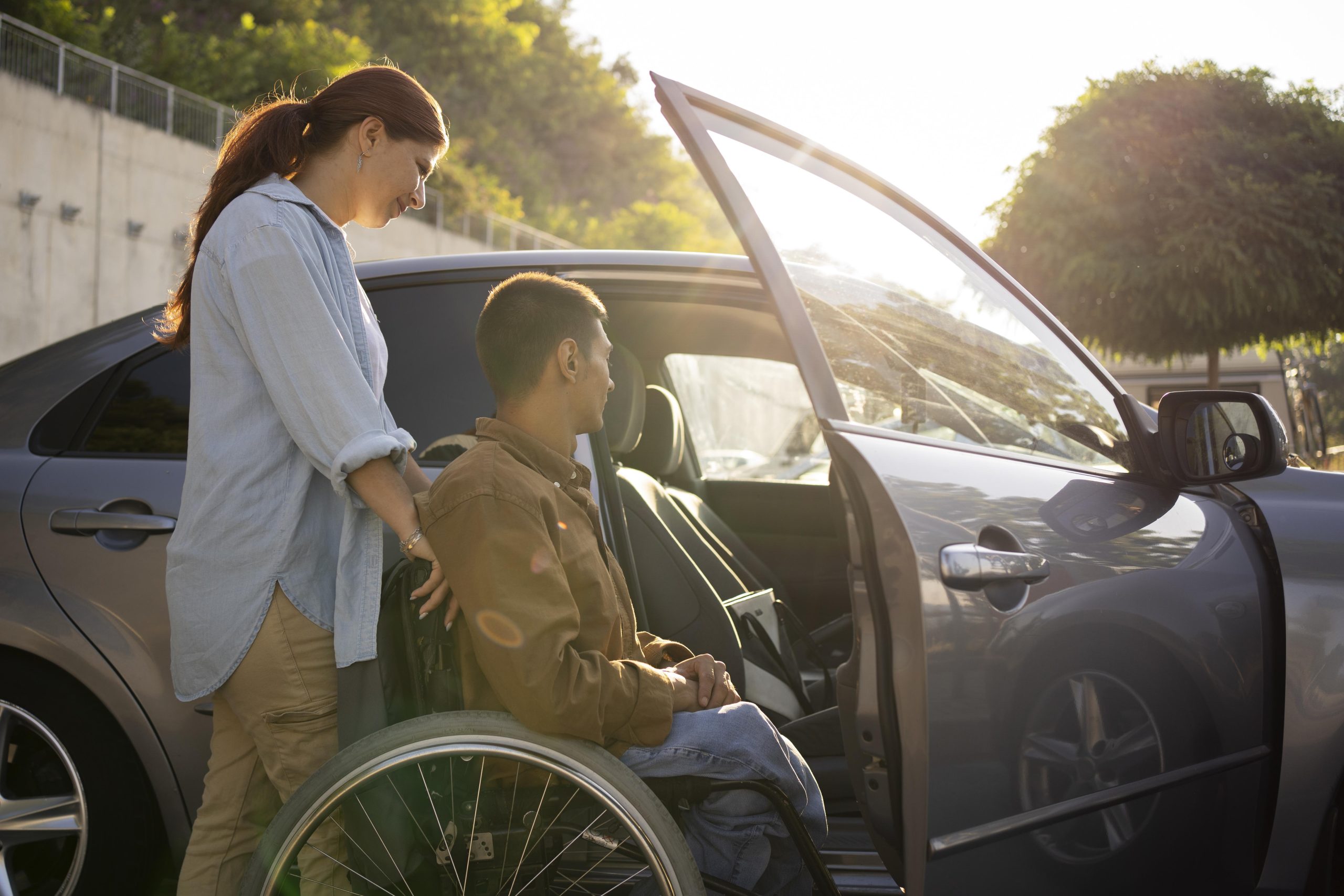 NEMT Driver helping handicapped person into car